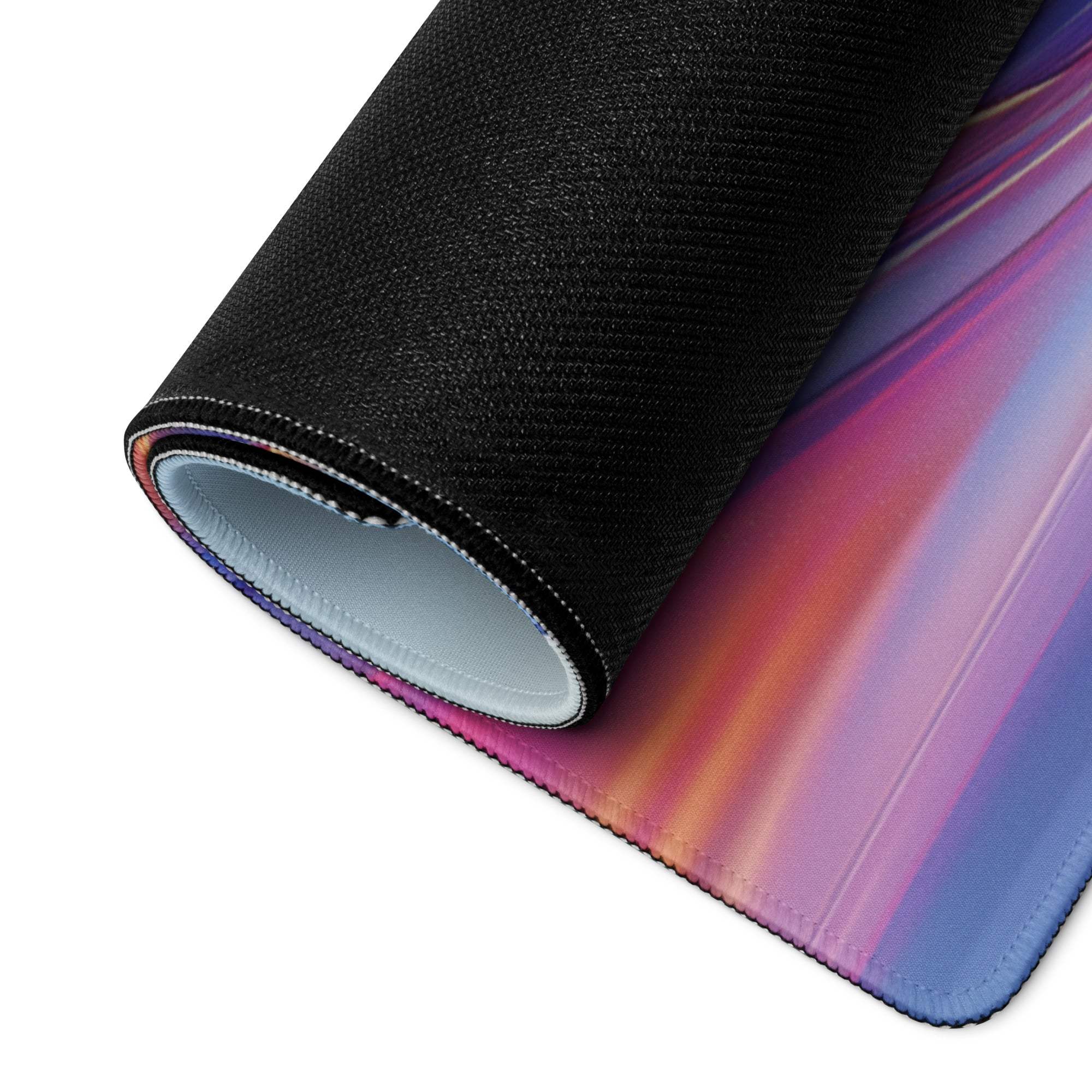 Rolled-up premium large gaming mouse pad in vibrant pink to yellow gradient