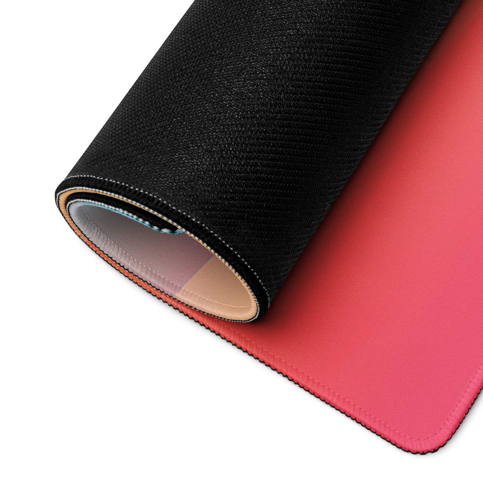 Rolled-up vibrant sunset gradient gaming mouse pad with stitched edges
