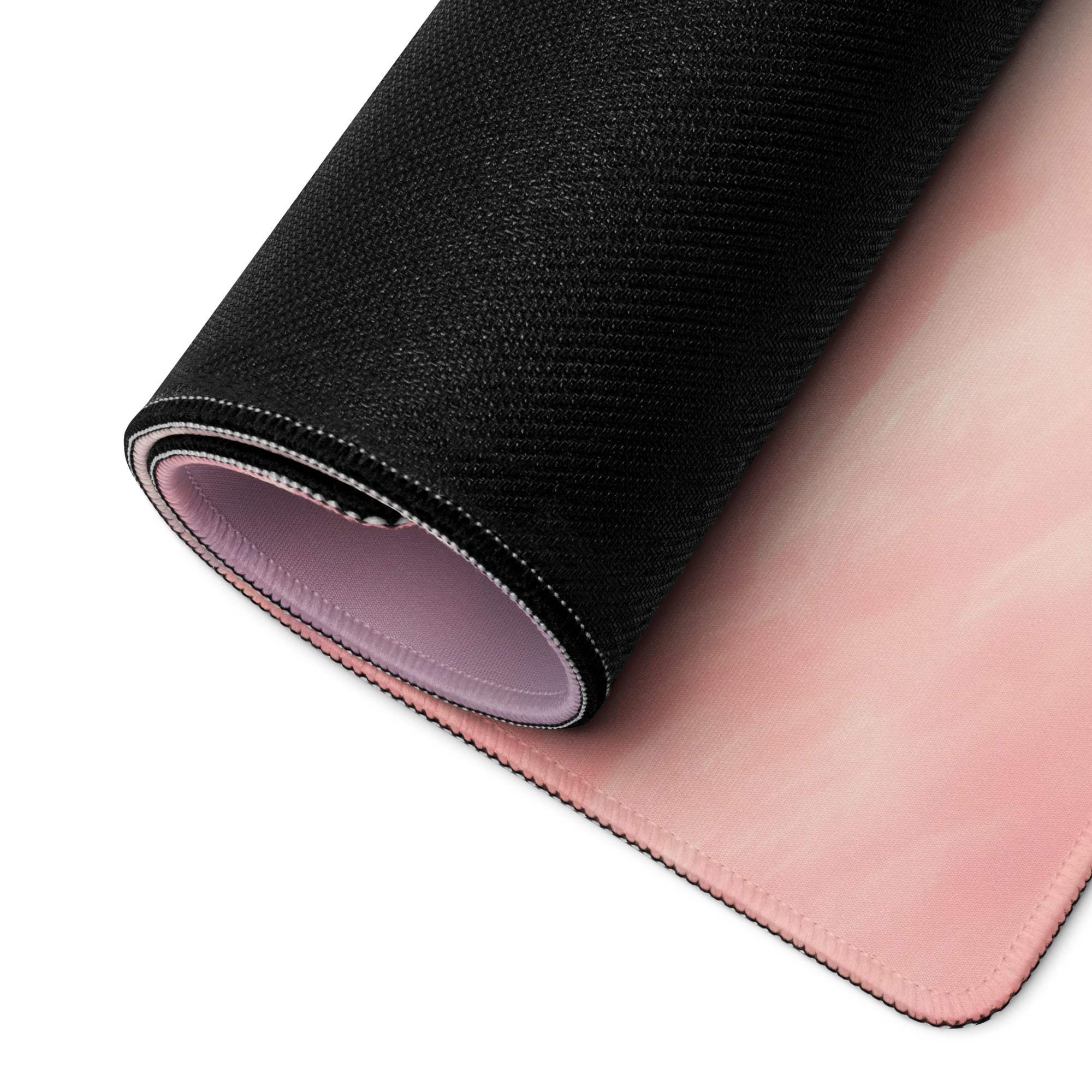 Dreamy pink cloud gaming mouse pad with black textured surface, stitched edges