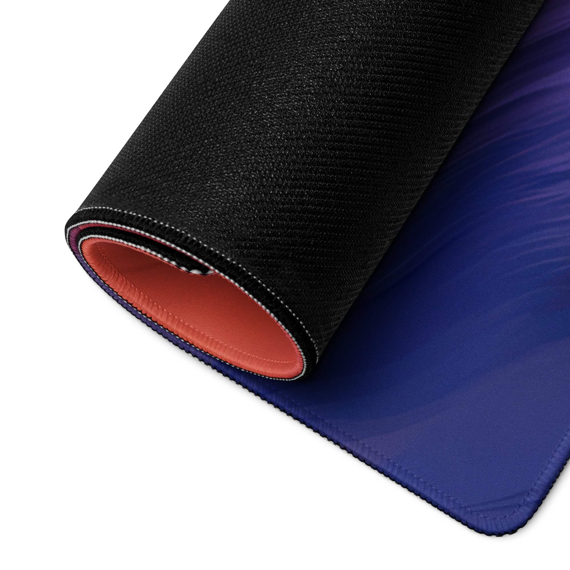 Rolled black blue gaming mousepad revealing orange lining, non-slip base
