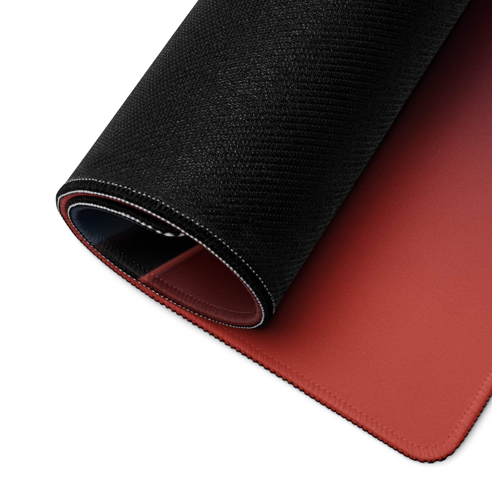 Back of large black and rust-red wave gaming mousepad with textured surface