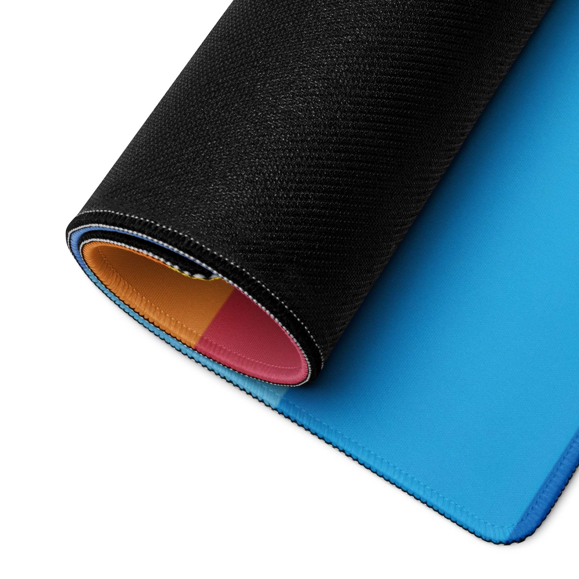 Large rainbow gradient gaming mouse pad with blue center, non-slip base, durable stitching