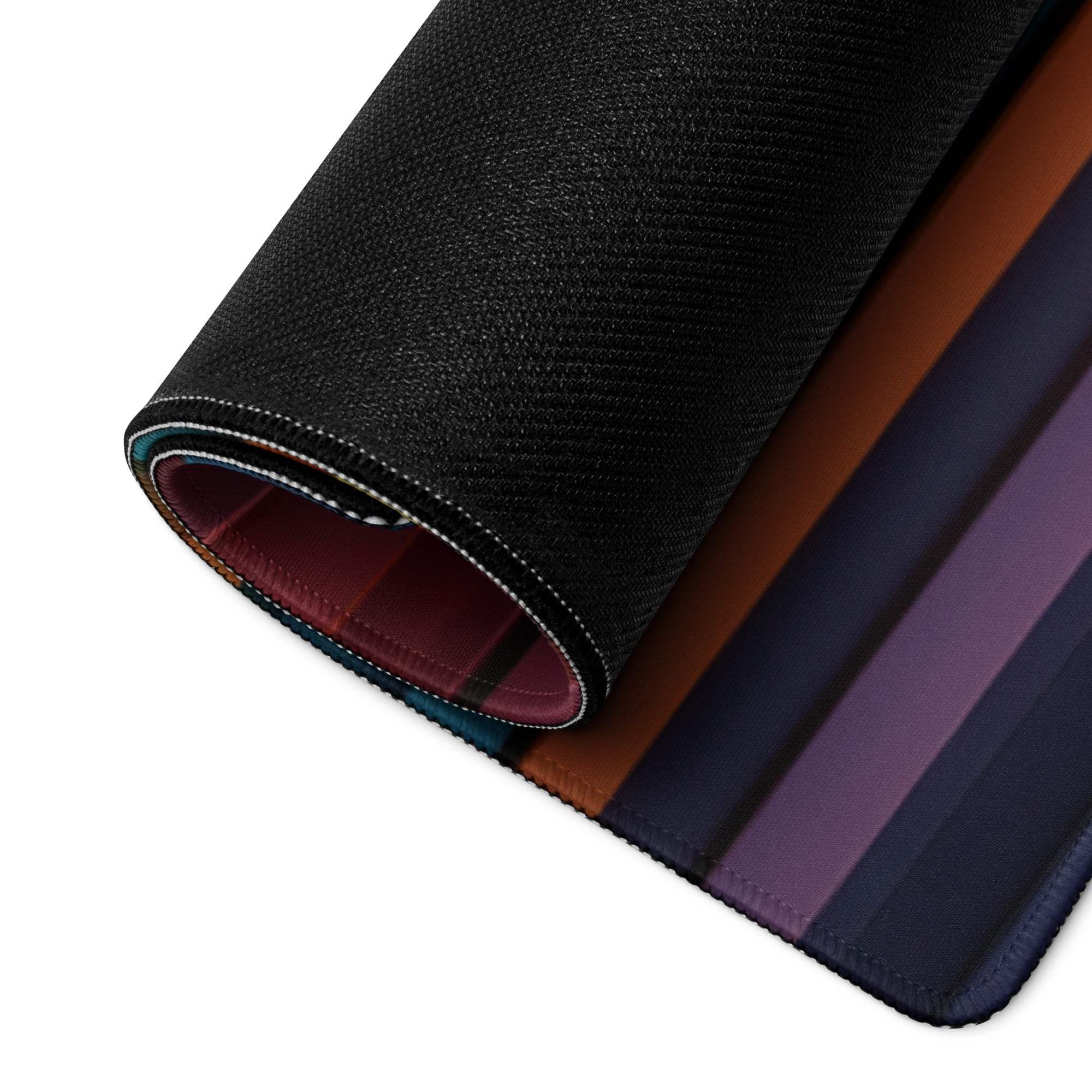 Rolled-up Vibrant Striped Spectrum gaming mouse pad with textured black exterior, gradient stripes, non-slip base and durable edge stitching