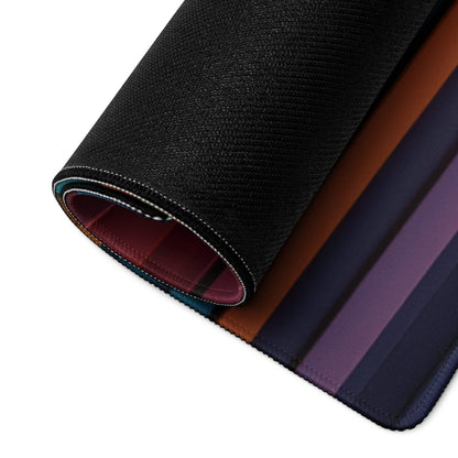 Rolled-up Vibrant Striped Spectrum gaming mouse pad with textured black exterior, gradient stripes, non-slip base and durable edge stitching