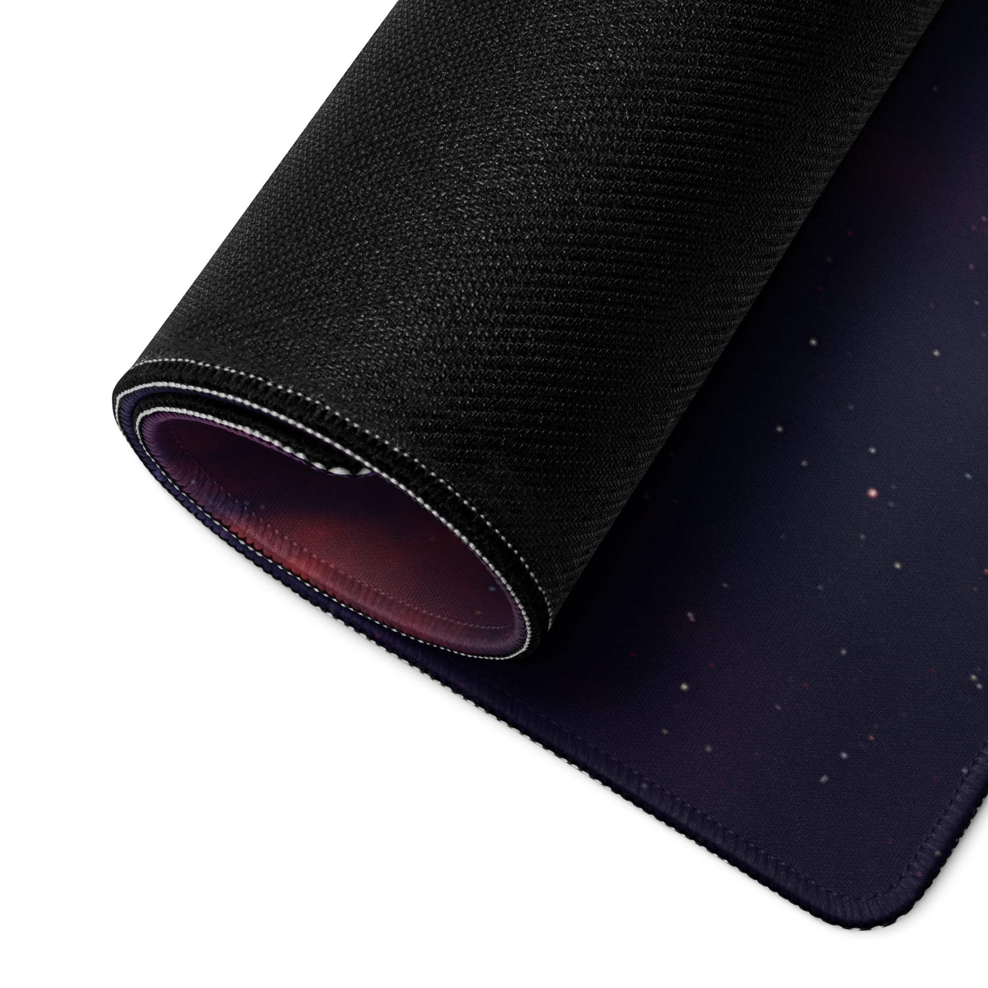 Black cosmic nebula mousepad rolled to show stitched edge and lining