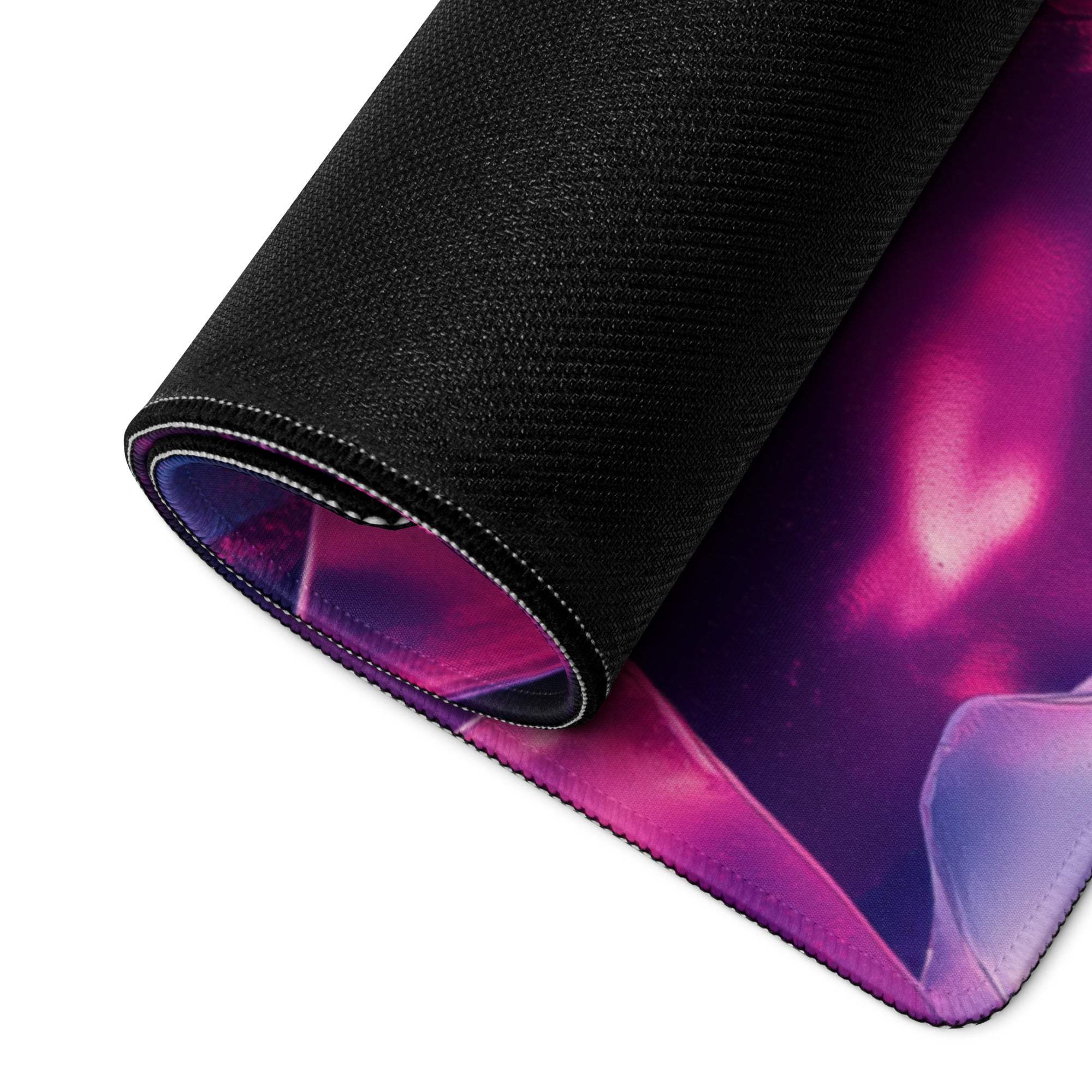 Rolled-up vibrant purple pink nebula gaming mousepad with non-slip black base