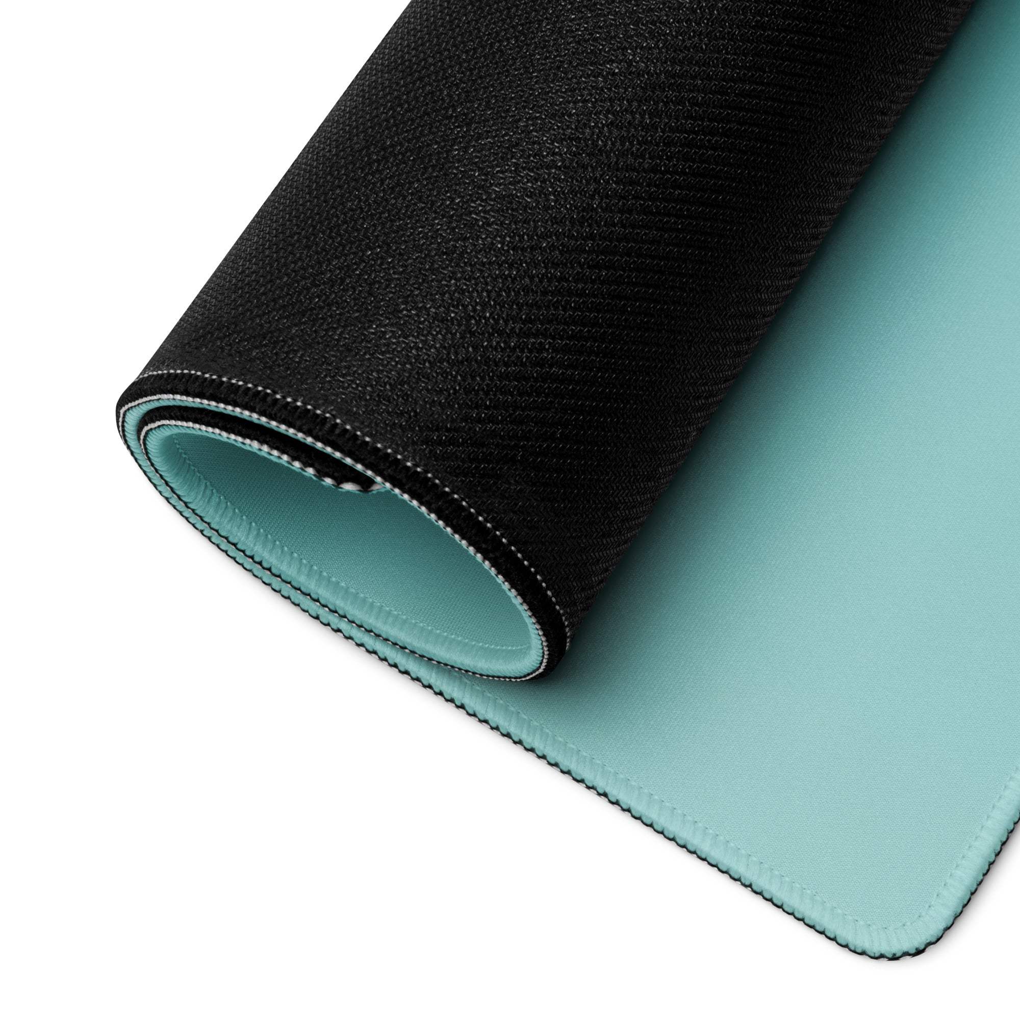 Black and teal back side of large gaming mousepad with textured surface
