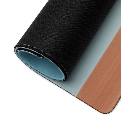 Back of minimalist desert landscape gaming mousepad with black texture, light blue underside, tan leather-like edge