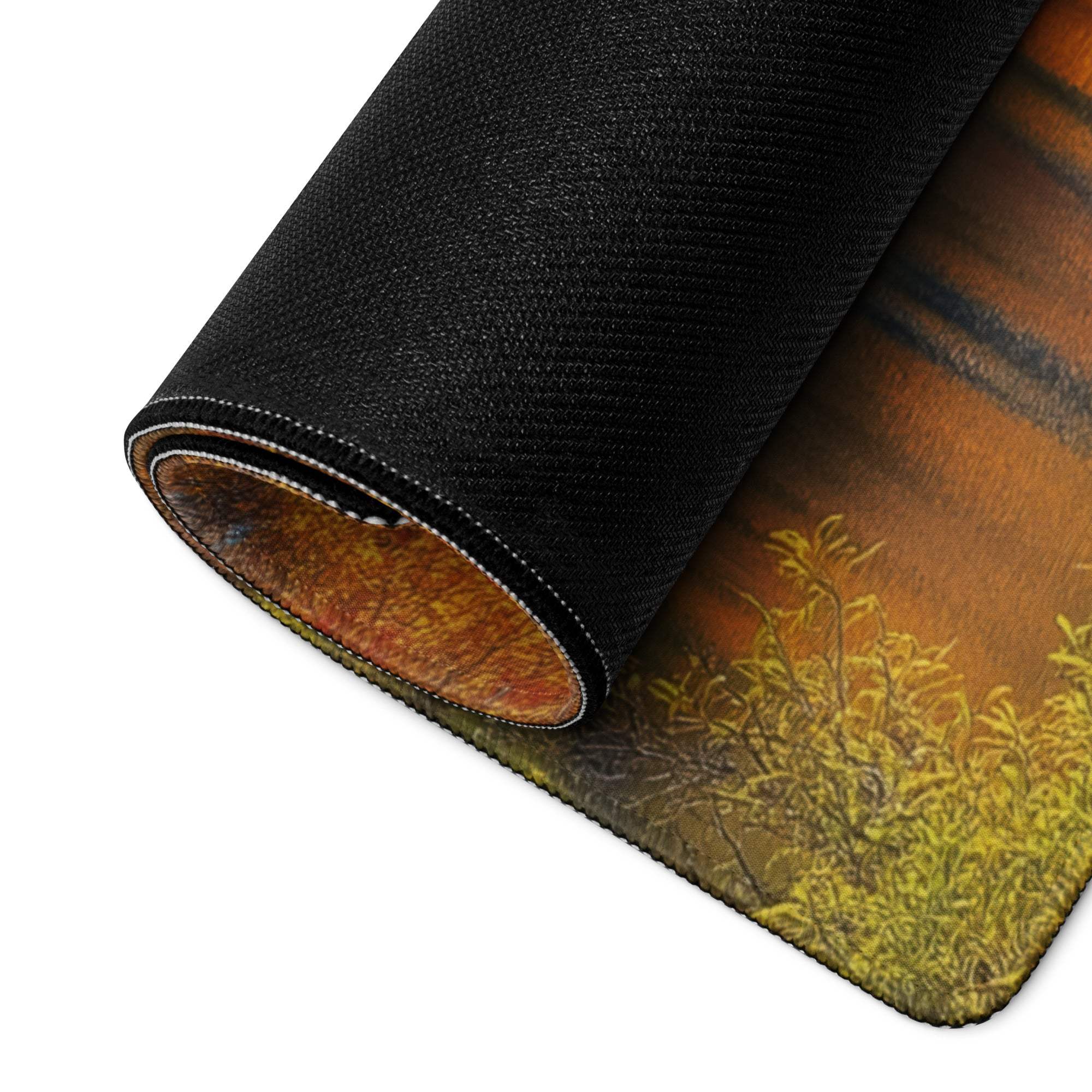 Black rolled-up Autumn Mountain Lake gaming mousepad in orange-yellow tones