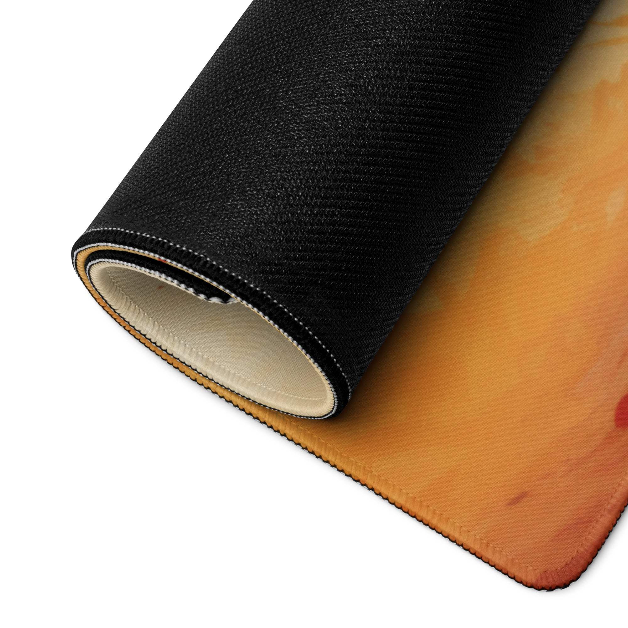 Black orange textured gaming mousepad rolled to show layered construction