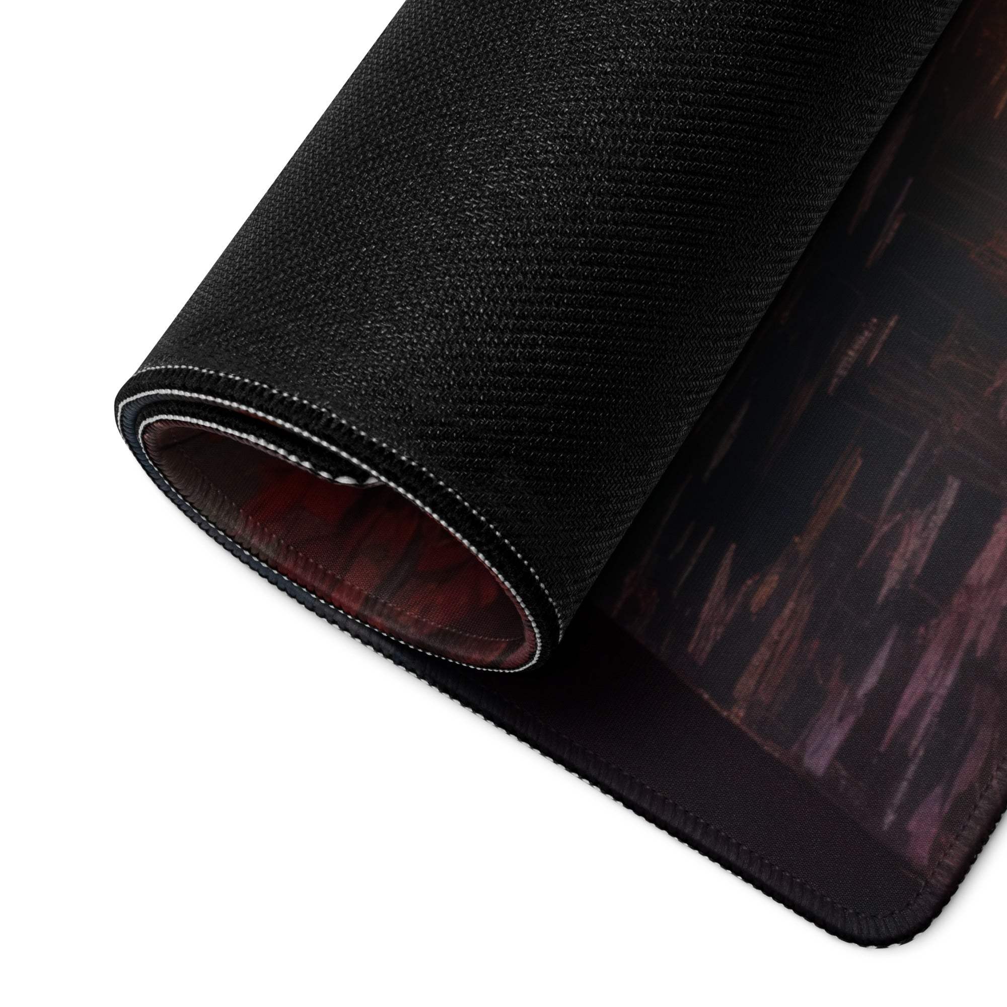 Black textured gaming mousepad with dark abstract design and white edge stitching