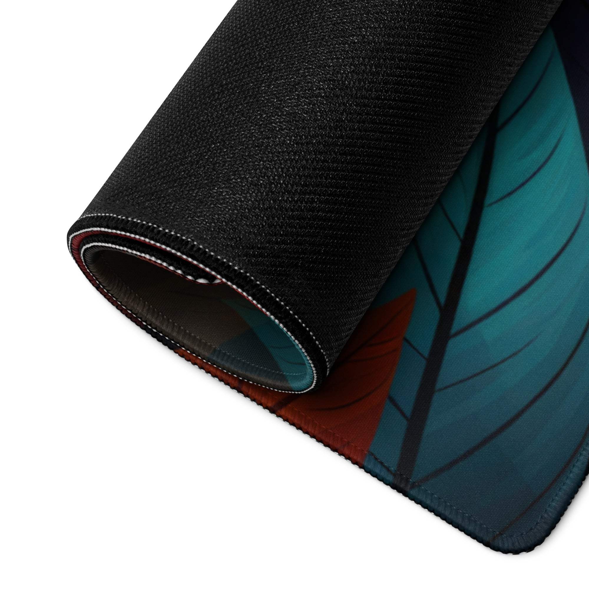 Black textured gaming mousepad with rolled edge showing teal red autumn leaves design