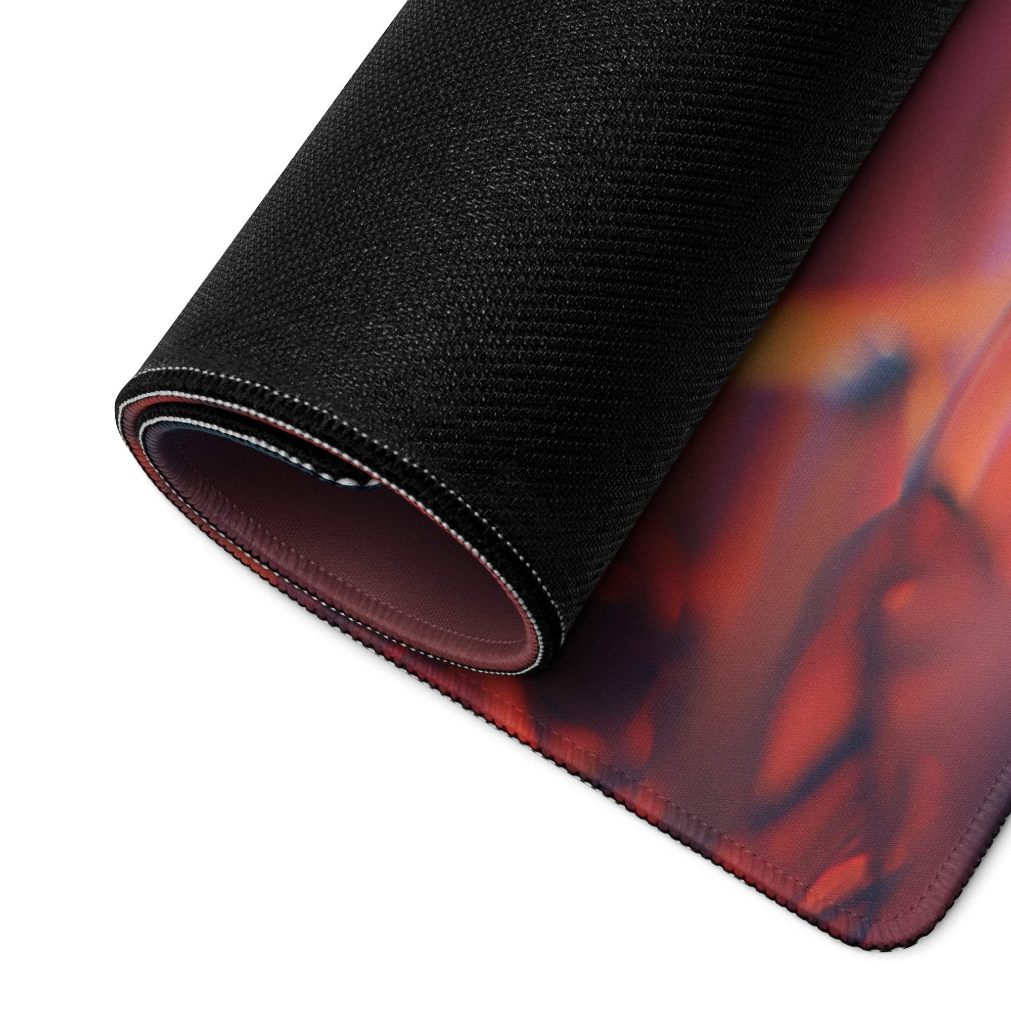 A rolled-up black gaming mousepad with a vibrant red and orange moonlit gothic halloween village design