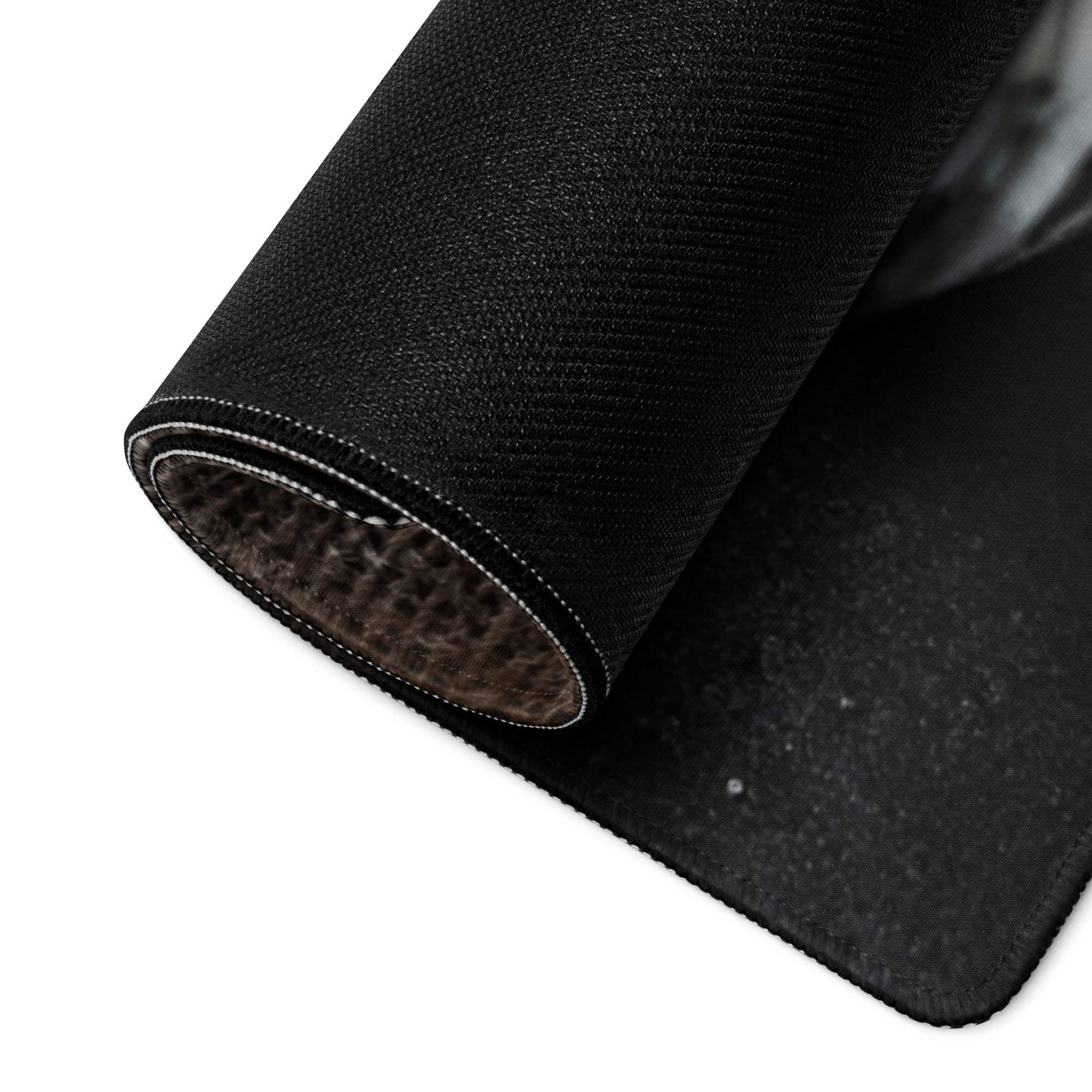 Black textured gaming mouse pad with woven surface and stitched edges