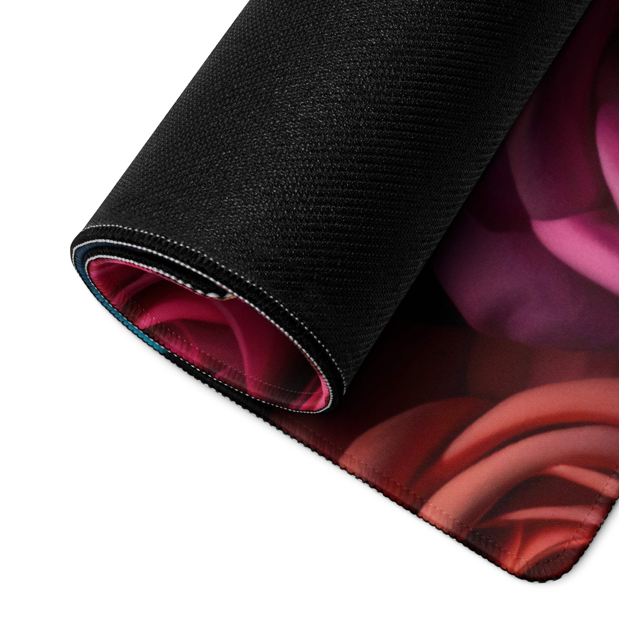 Rolled-up black gaming mouse pad with vibrant pink red rose design