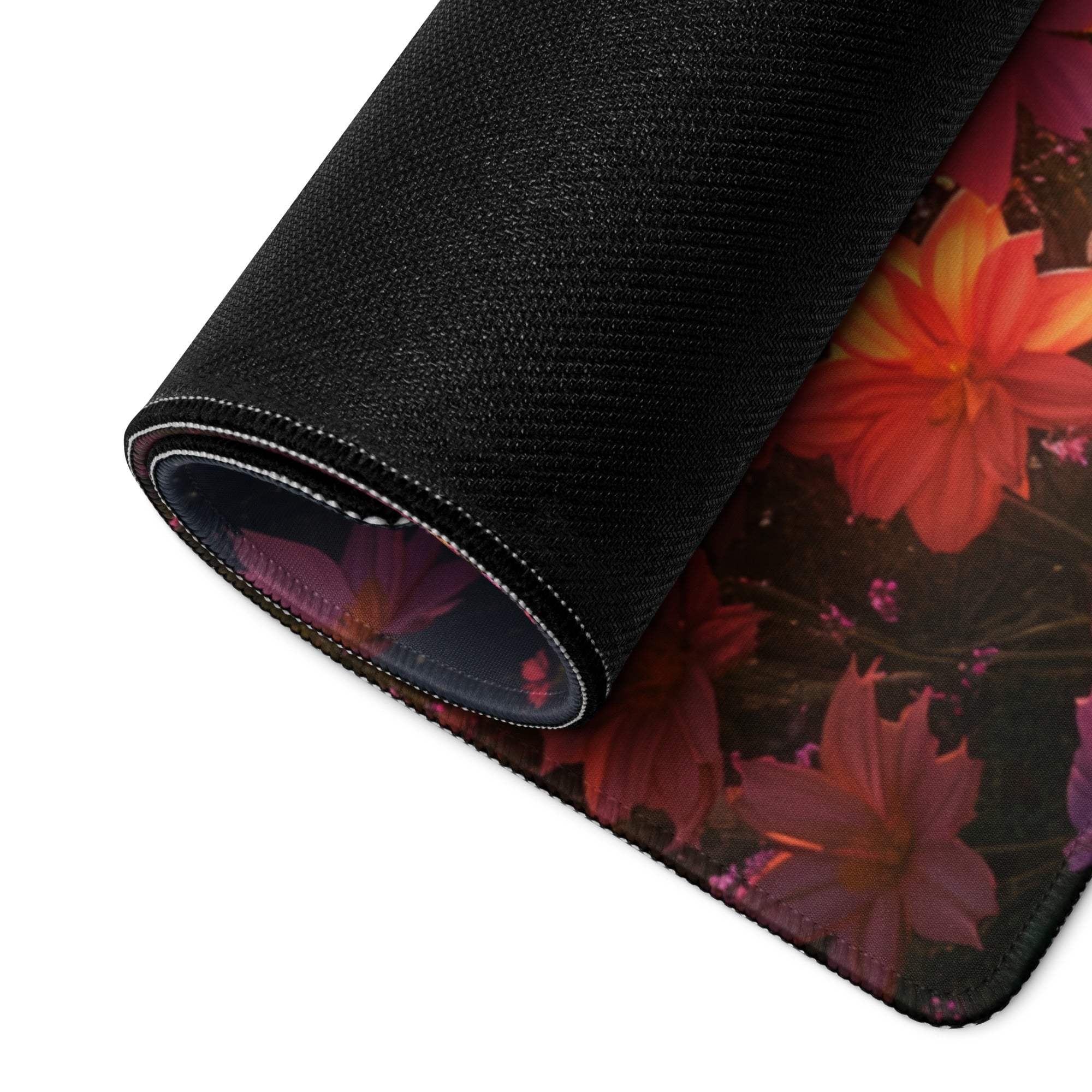 Black floral gaming mousepad with red orange blossoms, non-slip base, stitched edges