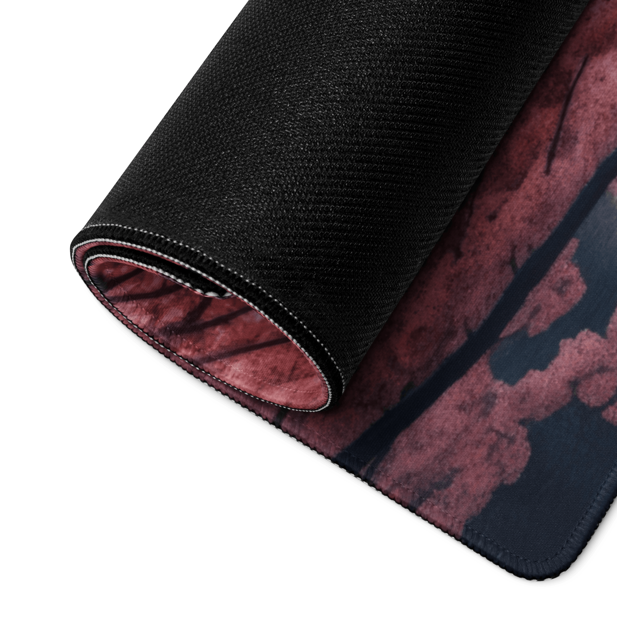 Black textured gaming mousepad back with red cherry blossom, pink mountain design, white stitching