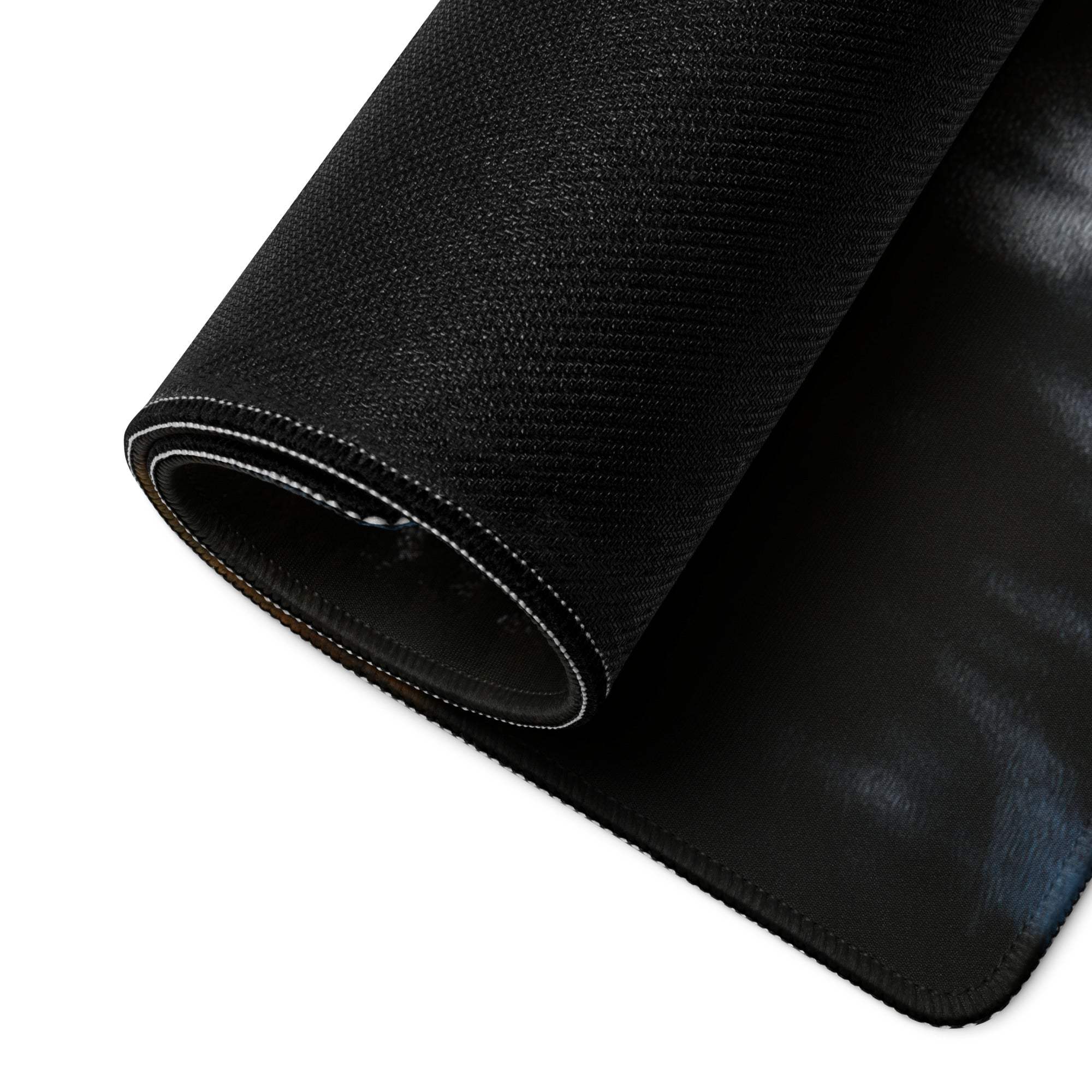 Black textured back of Autumn Forest gaming mousepad with sheen, reinforced edges