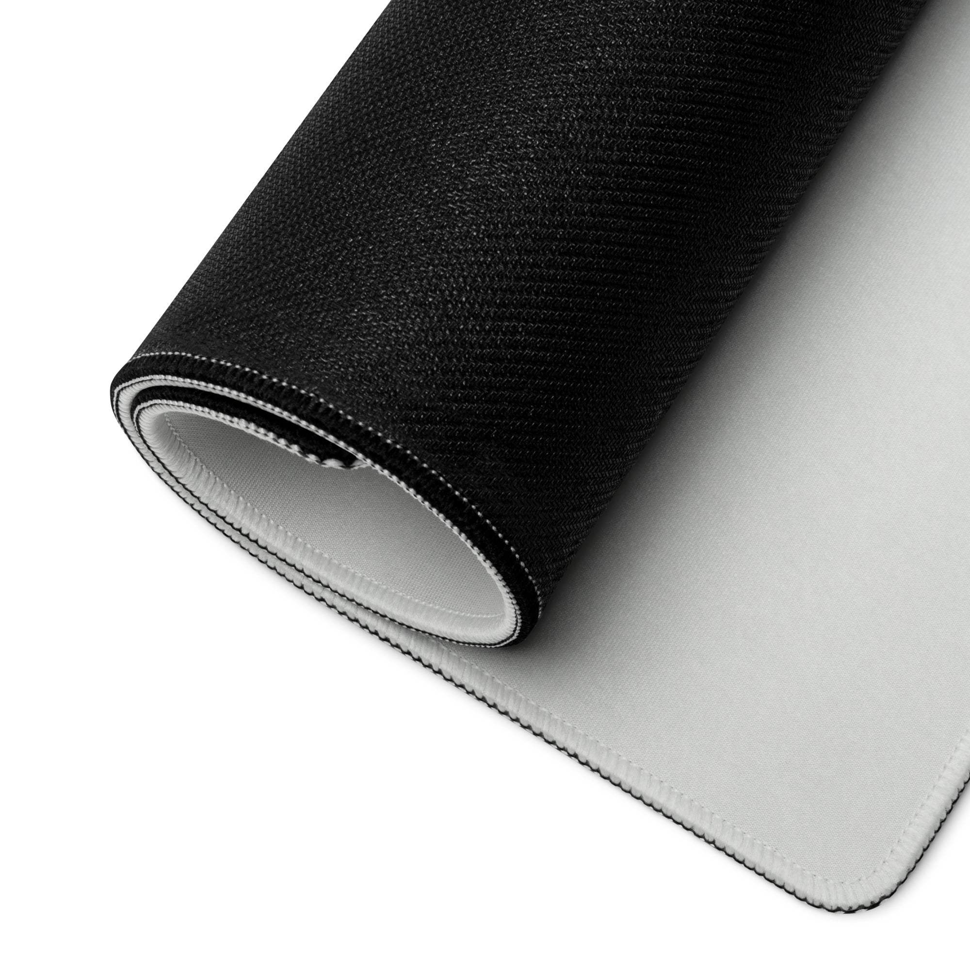 Black and white reversible gaming mousepad with textured and smooth sides shown rolled