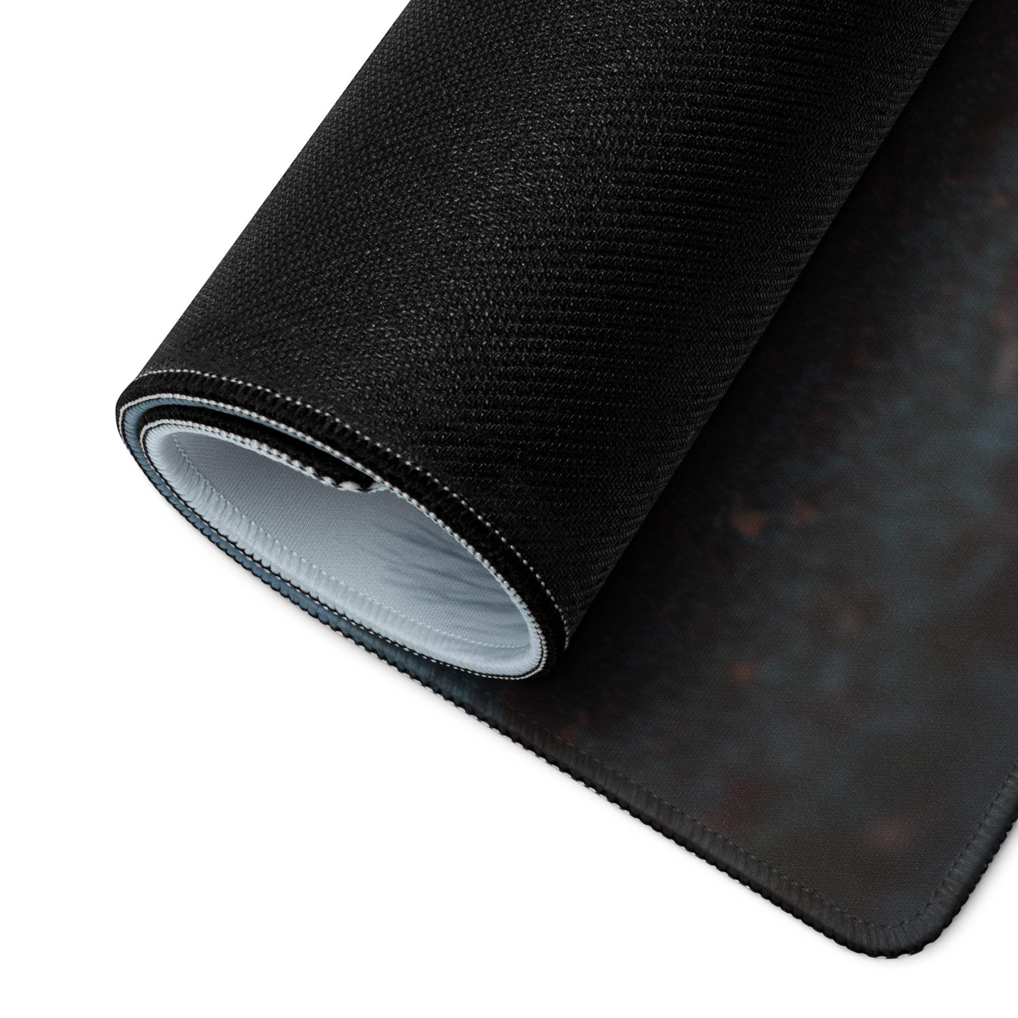 Black textured gaming mousepad with stitched edges, rolled to show gray lining