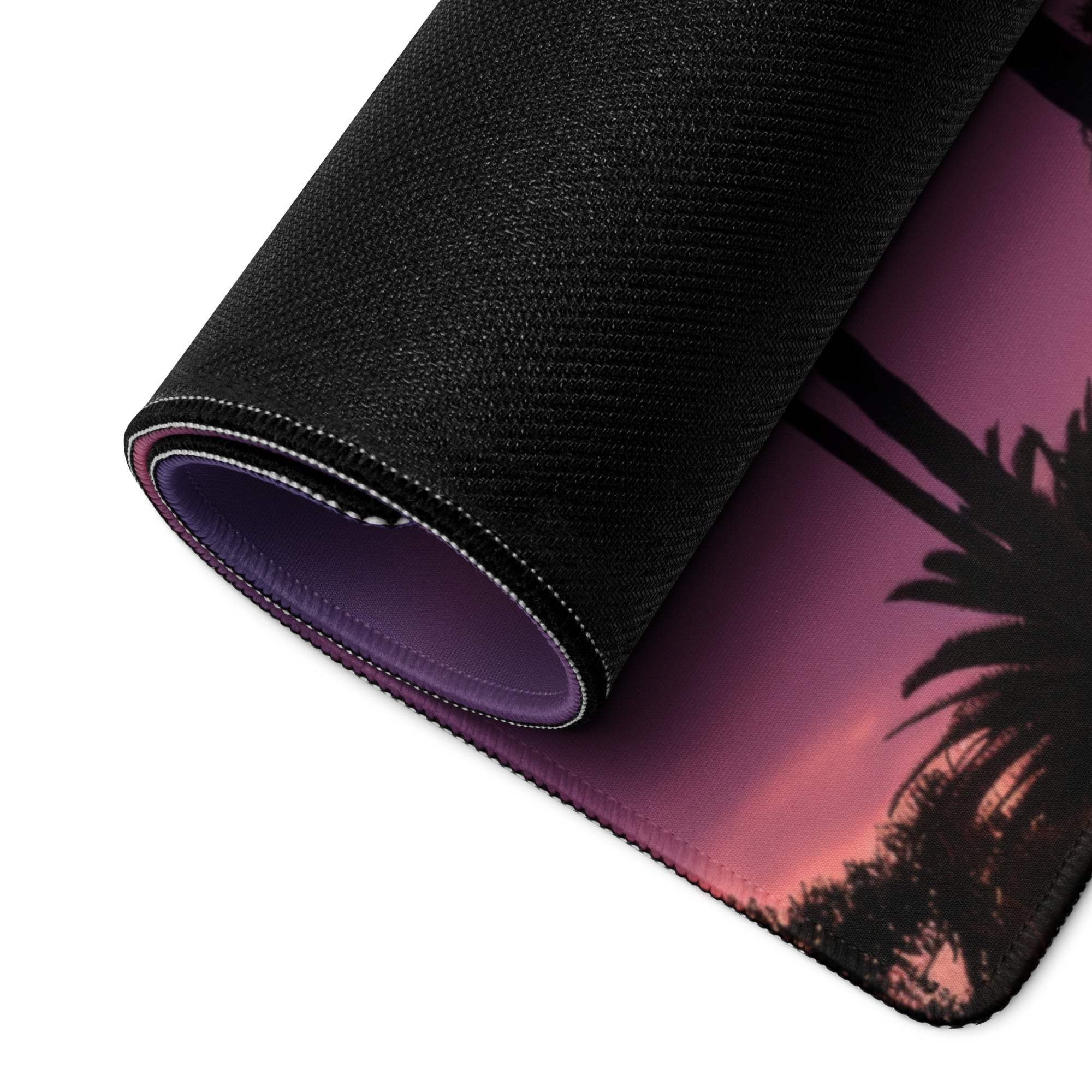 Rolled-up large gaming mouse pad with purple pink sunset palm trees and non-slip backing