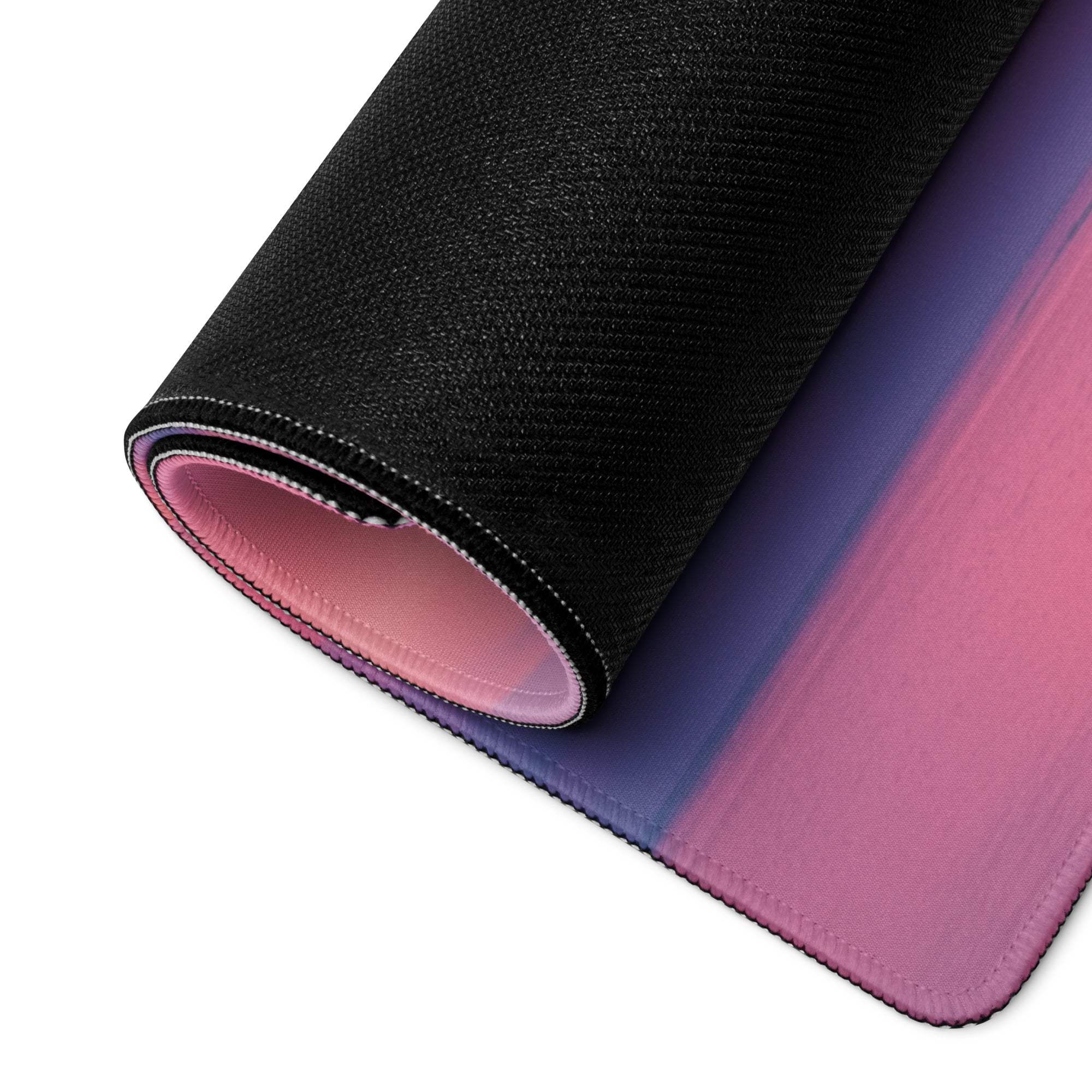 Rolled-up Dreamy Sunset black-pink gradient gaming mouse pad with stitched edges
