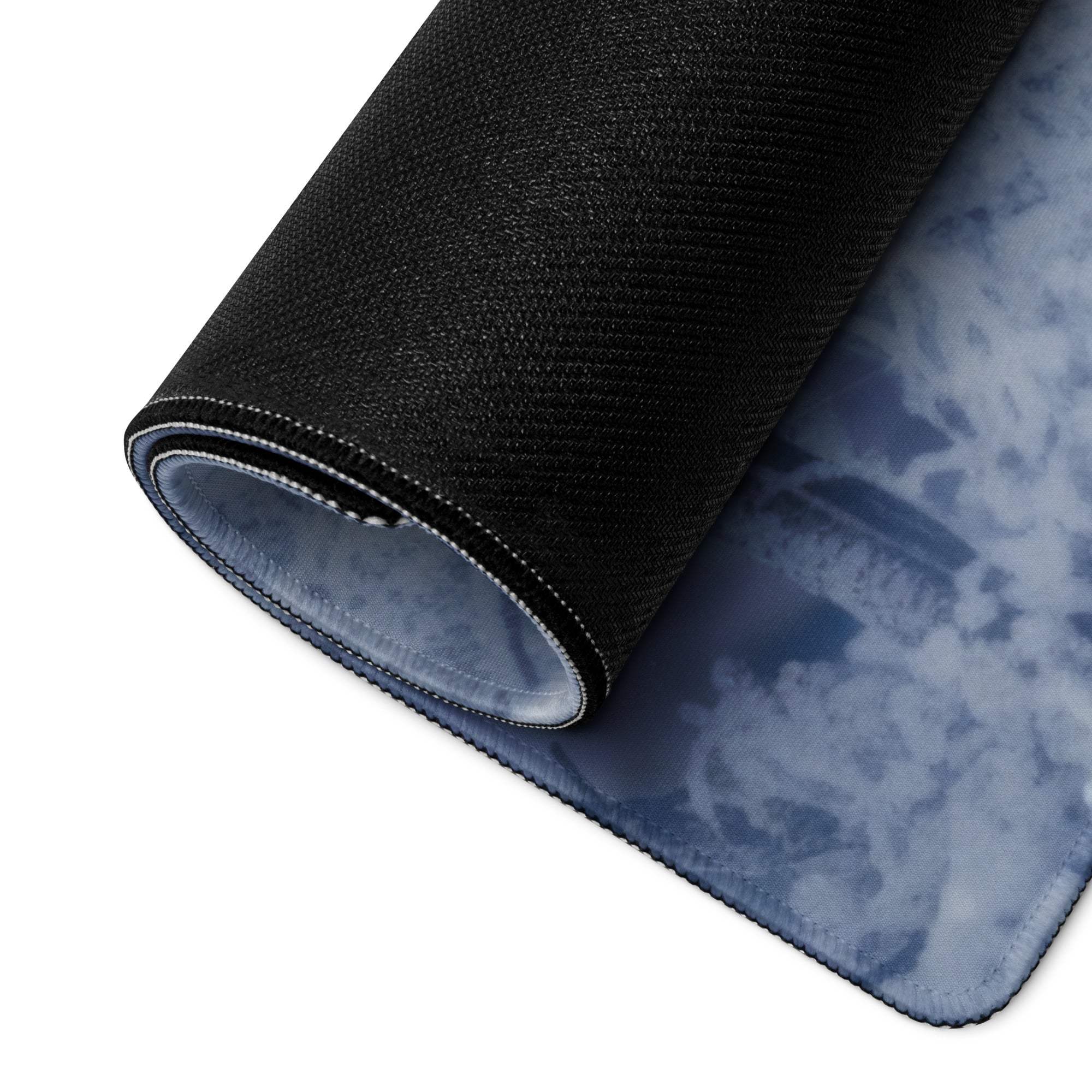 Rolled Frosty Blue Winter Forest mouse pad showing black textured non-slip cloud underside