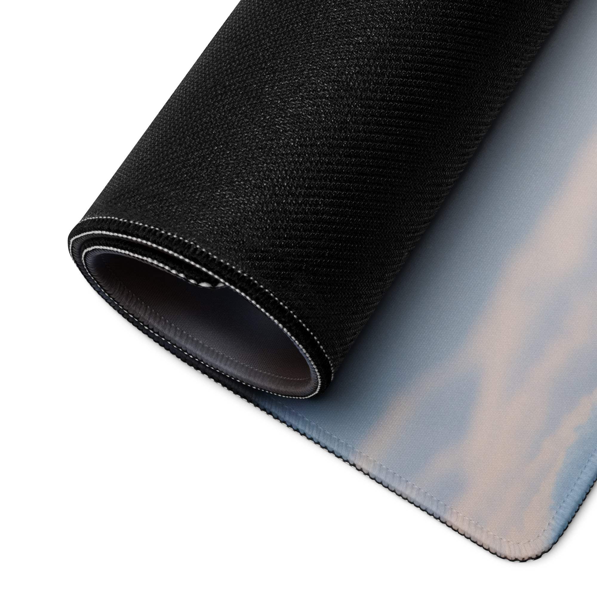Black textured gaming mousepad with sky clouds rolled to show Festive Winter Snowman scene