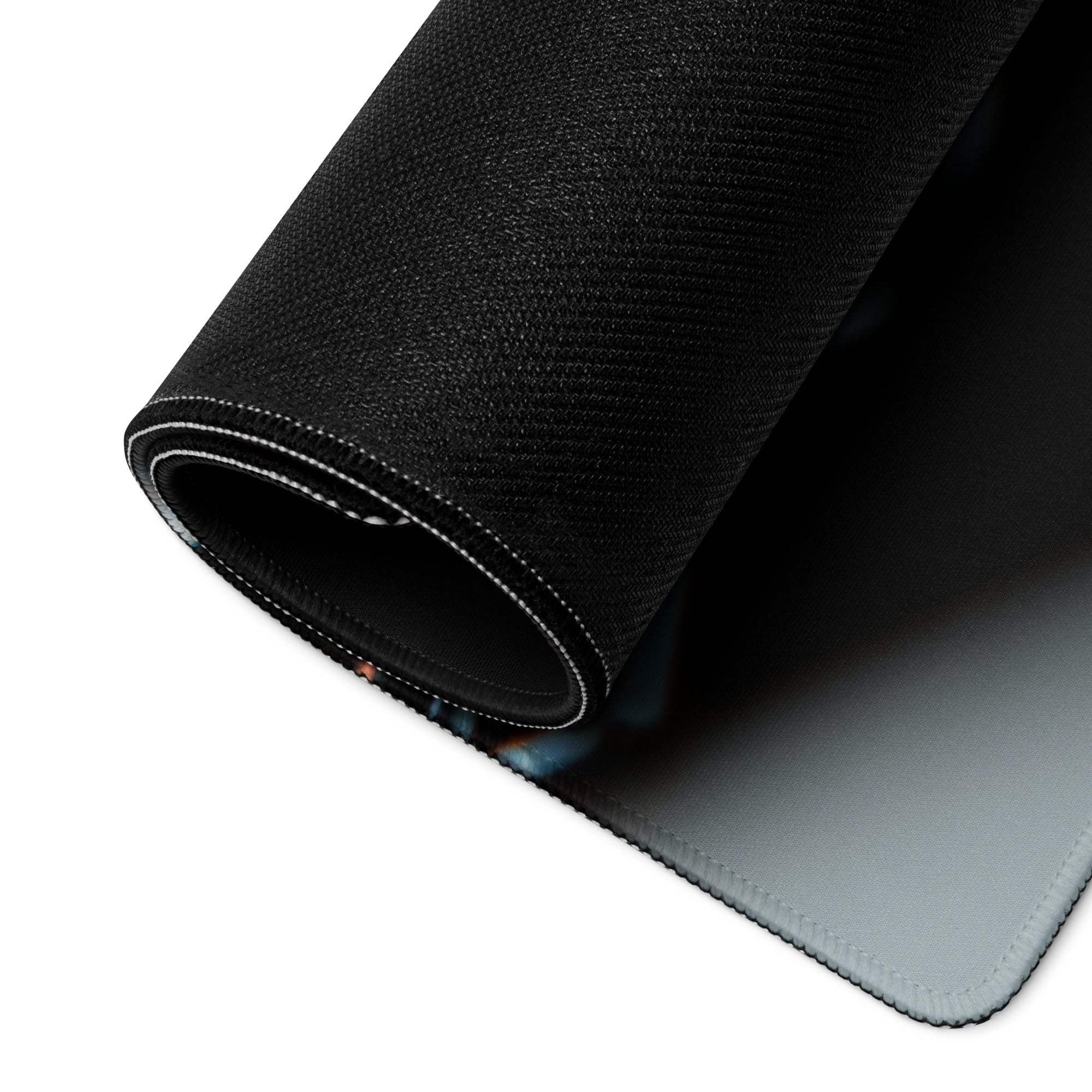 Black textured gaming mousepad with gray underside and white stitched edge
