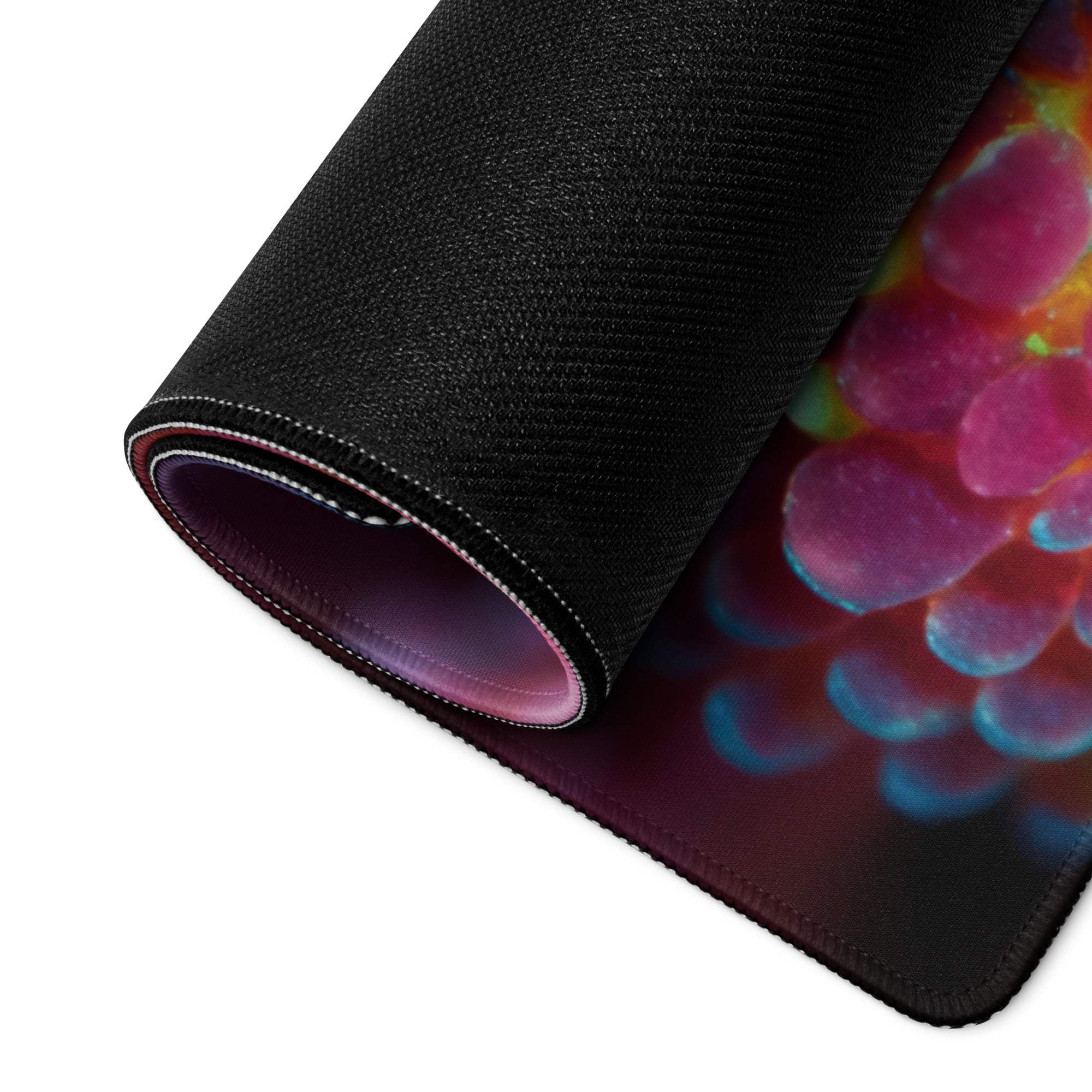Rolled-up black back of Vibrant Coral Reef gaming mouse pad with grapes print