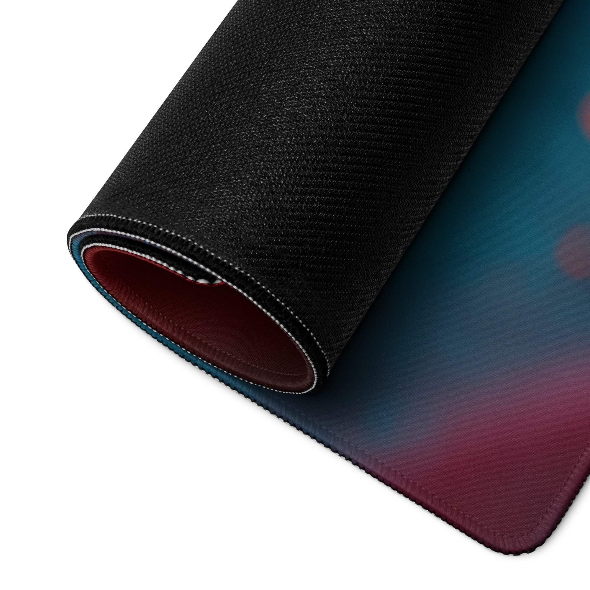 Vibrant black gaming mousepad with blue-to-red gradient, stitched edges, non-slip backing