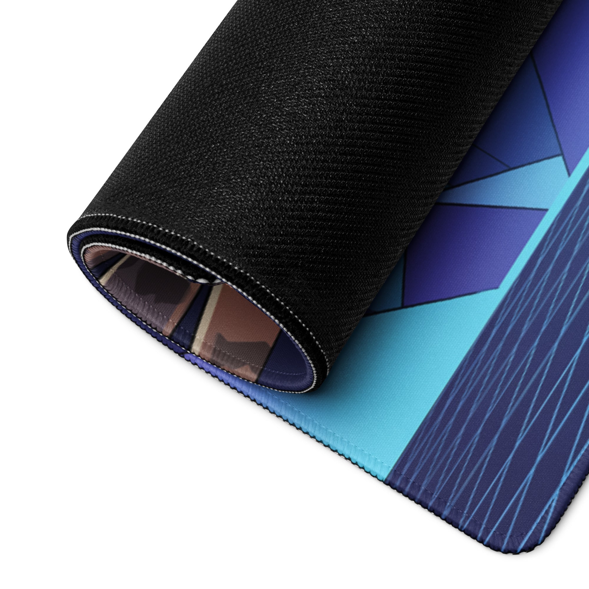 A rolled-up vaporwave angel flight mouse pad with black textured back and blue purple teal geometric design on surface