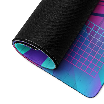 A rolled-up gaming mousepad with a vibrant pink purple and teal gradient design on a black textured surface