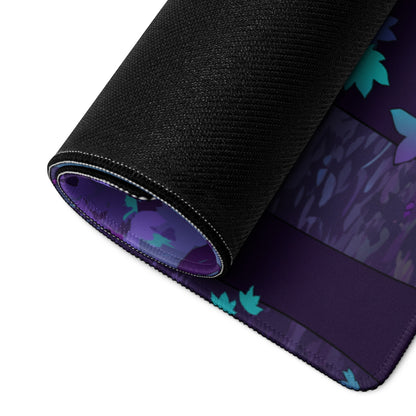 A rolled-up black gaming mousepad with a purple and teal leaf pattern vaporwave dragon nightscape design
