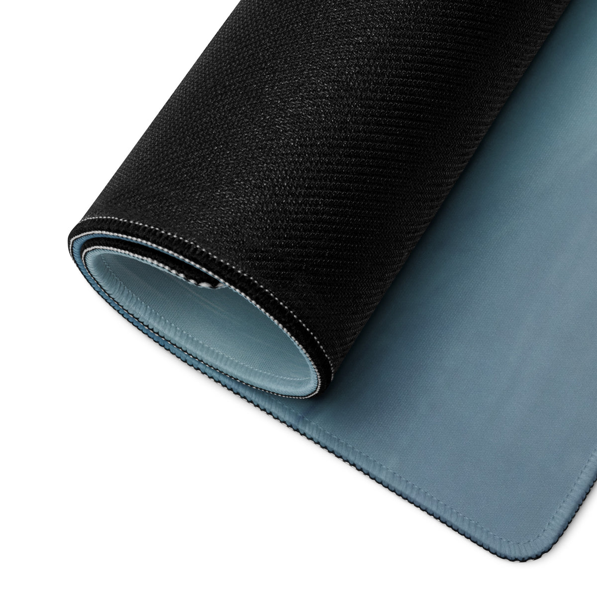 Ferrari 488 GT3 inspired motorsport desk mat with black textured outer layer and soft blue inner lining rolled to show dual tone design
