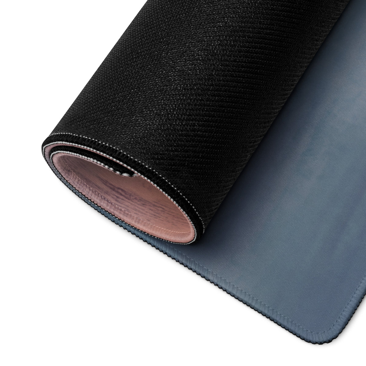 Ferrari 488 gtb inspired bianco edition desk mat with black textured outer layer and soft blue interior rolled to show layers