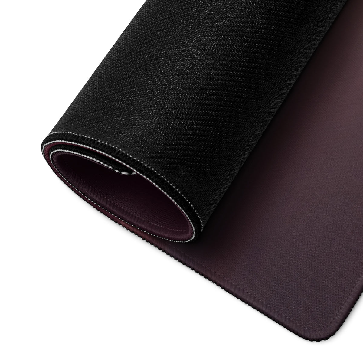 Black textured outer layer and dark brown leather interior of the ferrari sf90 xx inspired corsa blue desk mat rolled to show layers