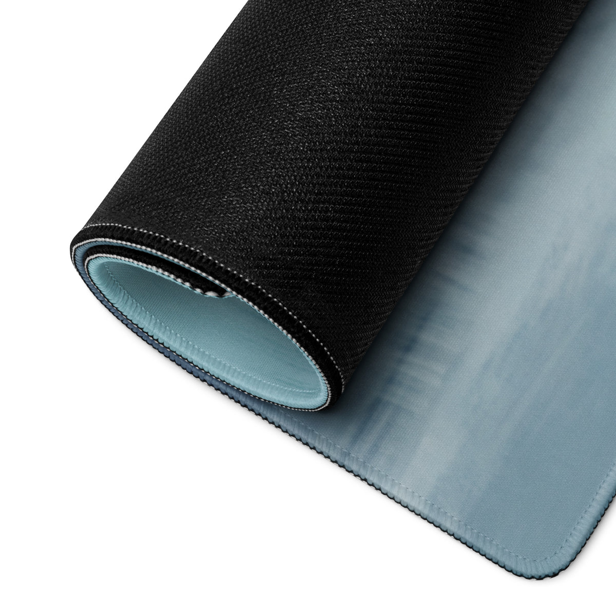 Ferrari 812 gts inspired rosso sunset desk mat with black textured outer layer and light blue cloth inner lining shown rolled