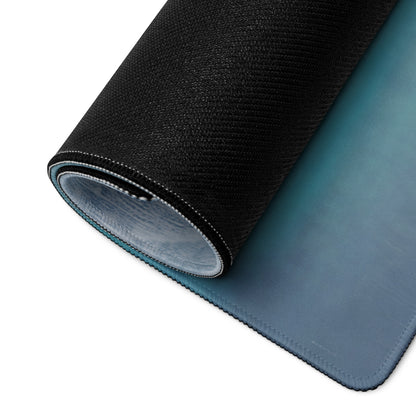 Black textured outer layer with smooth gradient blue inner surface on rolled-up mclaren 720s stealth shadow desk mat
