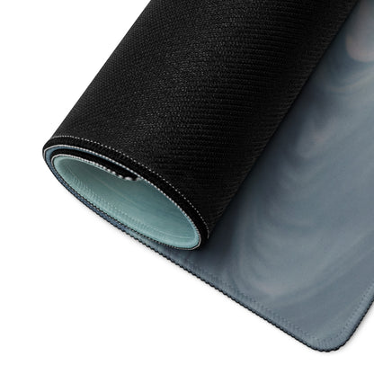 Rolled up Lamborghini Gallardo inspired crimson drift desk pad with black textured outer layer and light blue lining showing layers