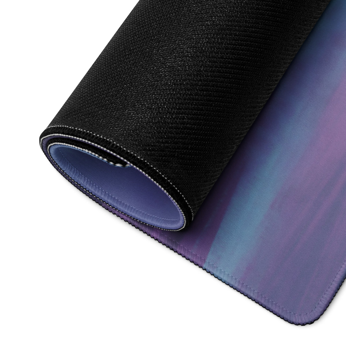 Ferrari 488 inspired pearl white extended non slip desk pad rolled up showing purple blue gradient surface and black edge