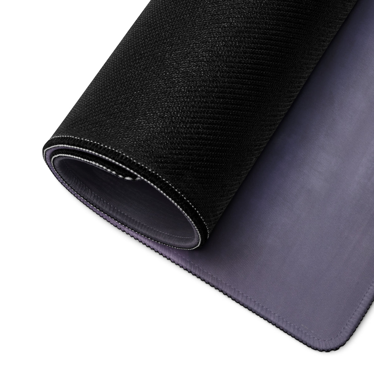 Black textured outer layer with smooth gray inner surface rolled to show dual-material design of Porsche 918 Spyder desk pad