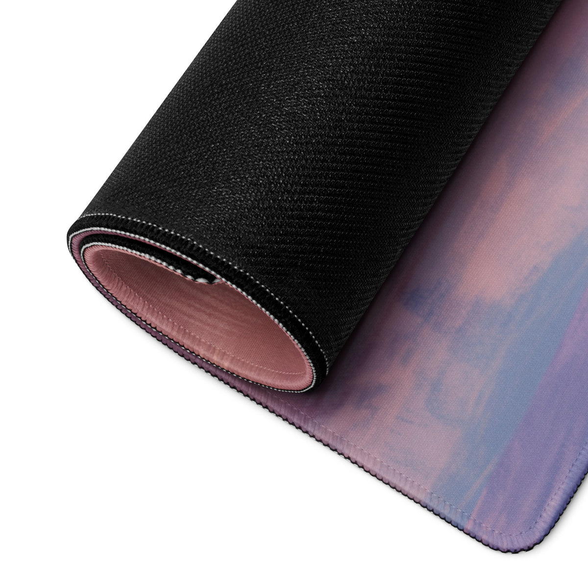 Rolled-up Porsche 911 GT3 inspired viper green desk mat with soft purple pink gradient cloth surface and black textured edge