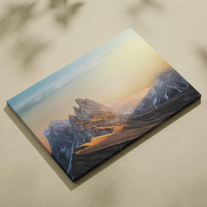 Cinematic mountain sunrise canvas wall art with jagged peaks glowing in warm golds and cool blues
