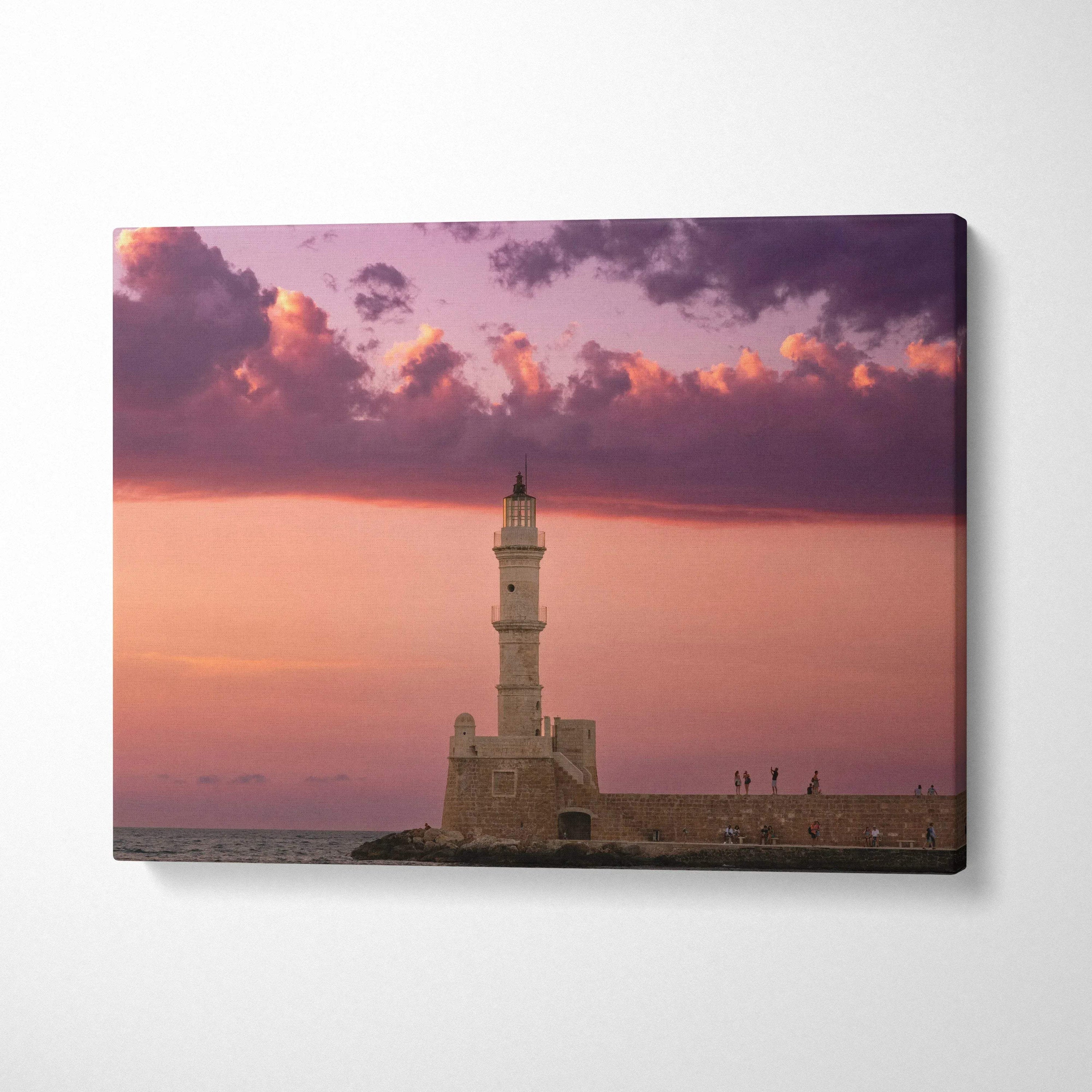 Canvas wall art featuring a lighthouse at sunset with purple and orange sky tones.