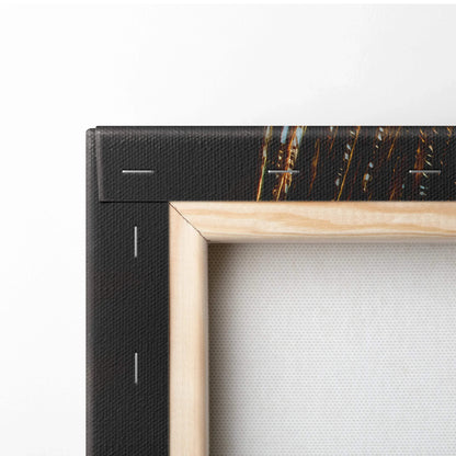 Close-up of corner beige wood frame and black canvas back with staples on wall art canvas.
