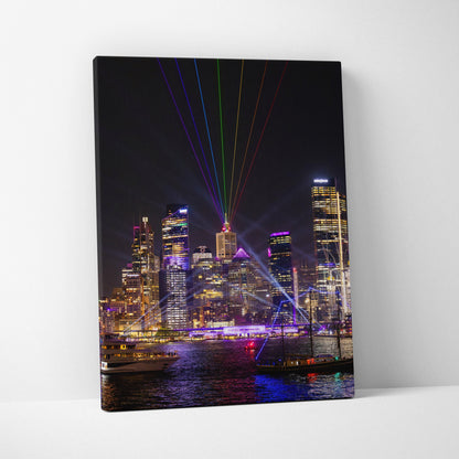 Urban nighttime skyline with colorful laser lights, vibrant cityscape canvas wall art print.