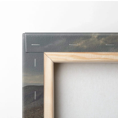Close-up of wooden frame edge and canvas texture on desert mountains wall art print.