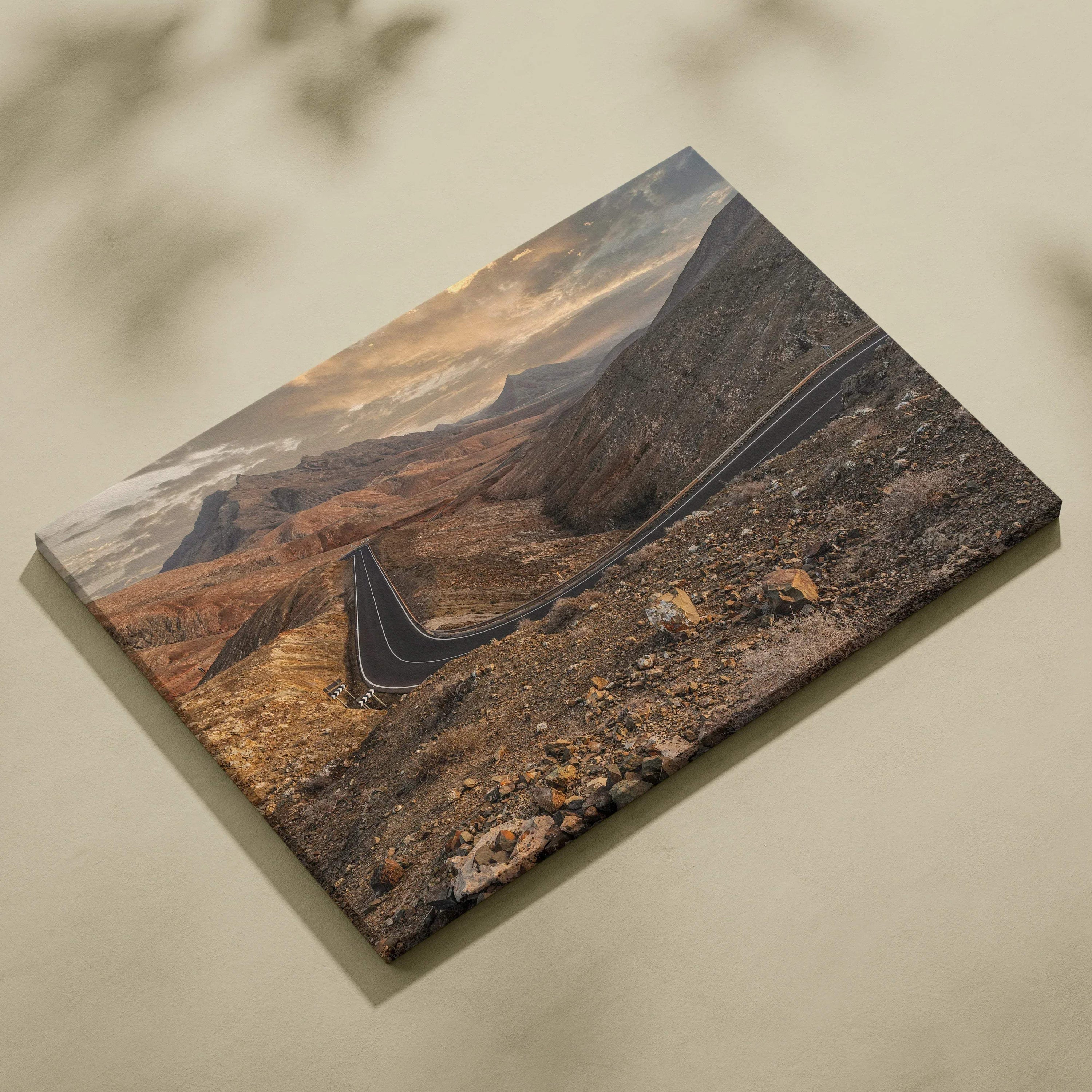 Desert mountains landscape canvas wall art with winding road under cloudy sky.