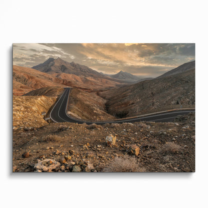 Mountain road winding through rocky terrain at sunset poster wall art print.